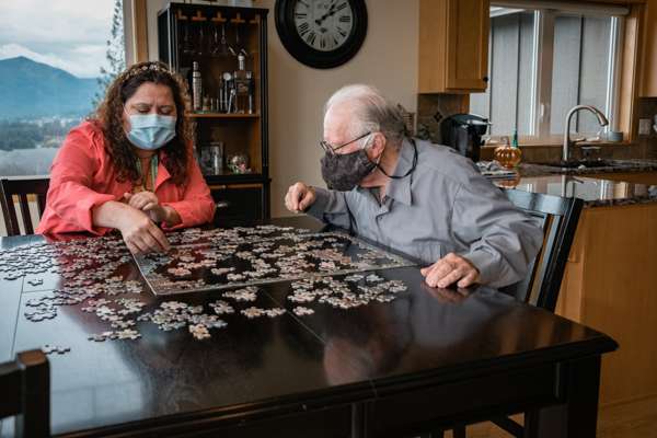 Volunteer and patient complete a puzzle