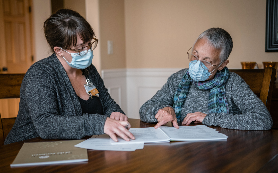 Social worker helping hospice patient fill out paperwork